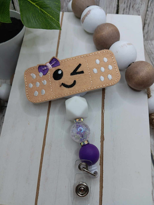 Embroidered Band-Aid w/ Purple Bow Beaded Badge Reel