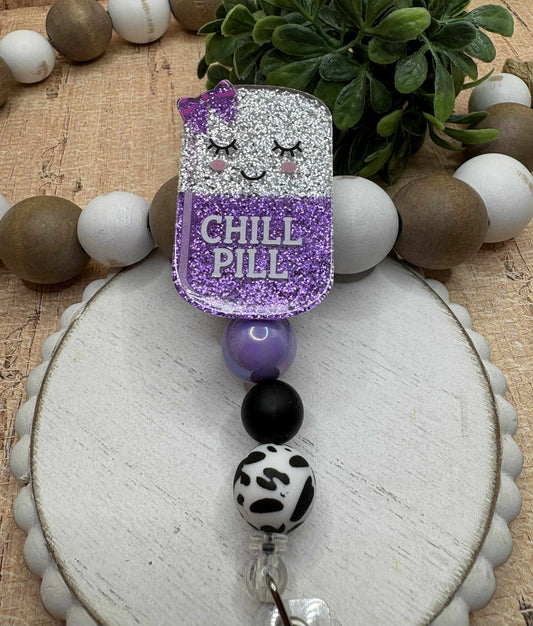 Chill Pill Glitter Beaded Badge Reel - Purple. Black, Cow