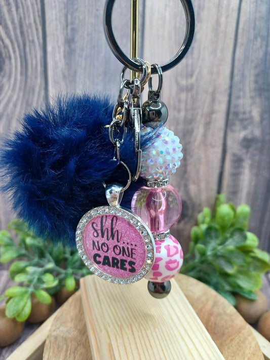 Shhh....NO ONE CARES Keychain Set w/ Blue Pom